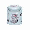 Hexagonal tea canister with vintage tea cup design on a light blue background