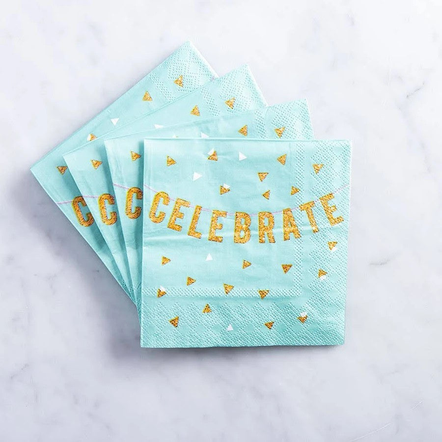 Turquoise napkins with gold 'CELEBRATE' text and confetti on a light gray background