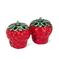 Two strawberry-shaped salt and pepper shakers on a white background