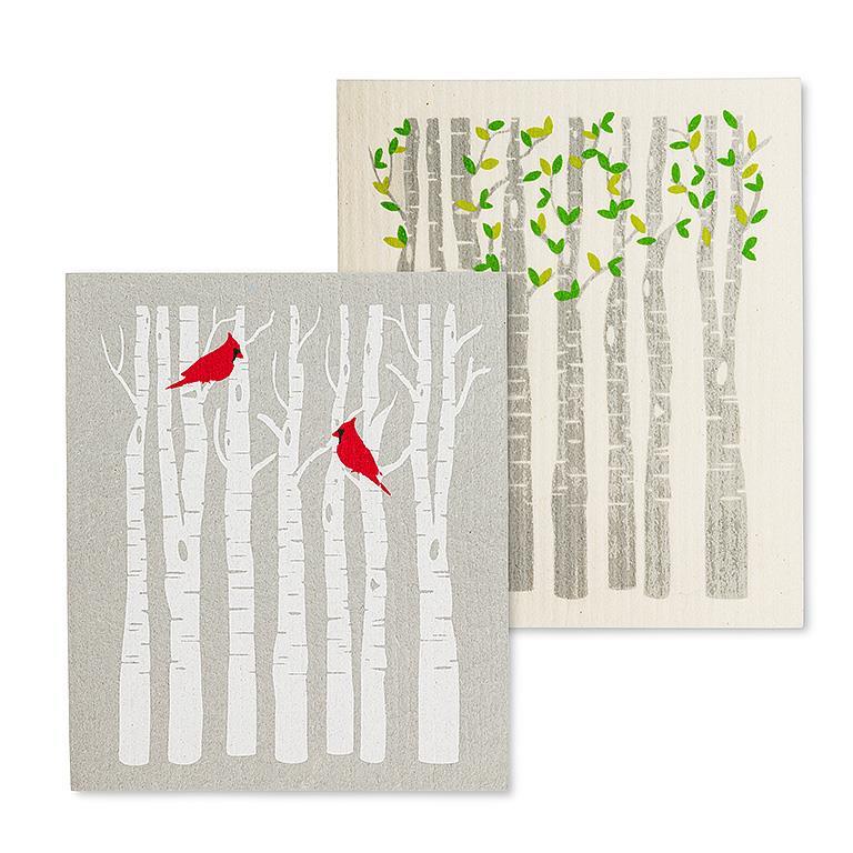 Two dish cloths with nature-themed designs featuring trees and birds on a white background.