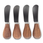 Four butter knives with wooden handles and black blades on a white background