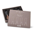 Set of four spreader knives in a brown packaging box on a white background