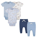 Set of baby clothes including bodysuits and pants on a white background
